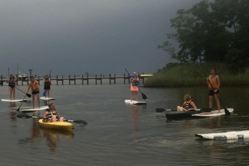 SUP riders and kayakers on an overcast day
