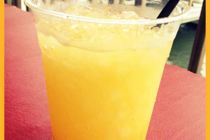 a close up of a glass of orange juice