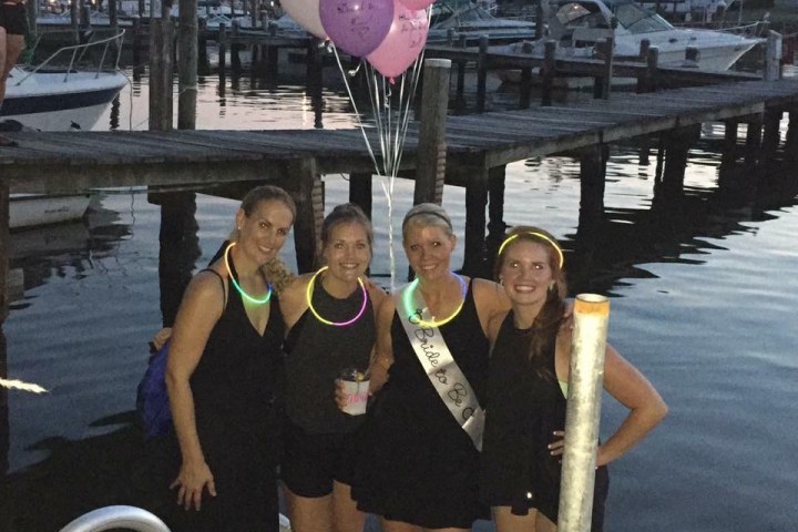 a group of people sitting at a dock