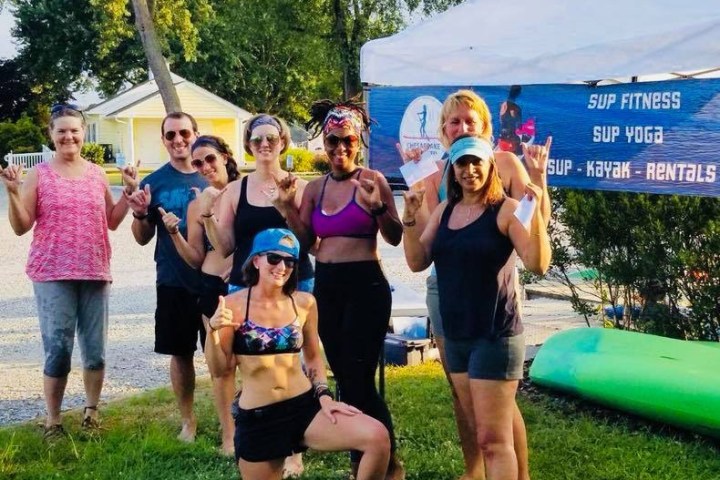 a group of people that are standing in the grass