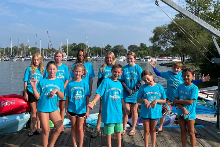 a group of people standing in front of a crowd posing for the camera