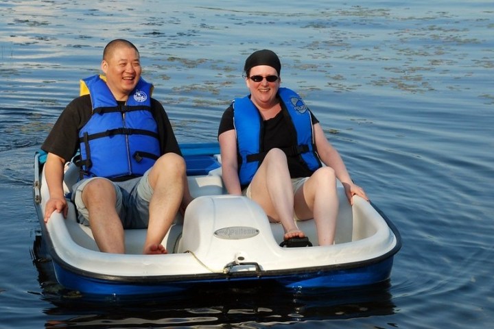 a person sitting on a boat in a body of water