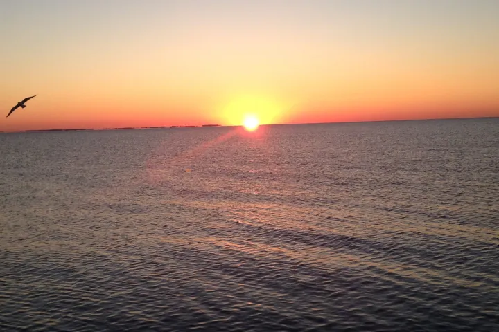a sunset over a body of water