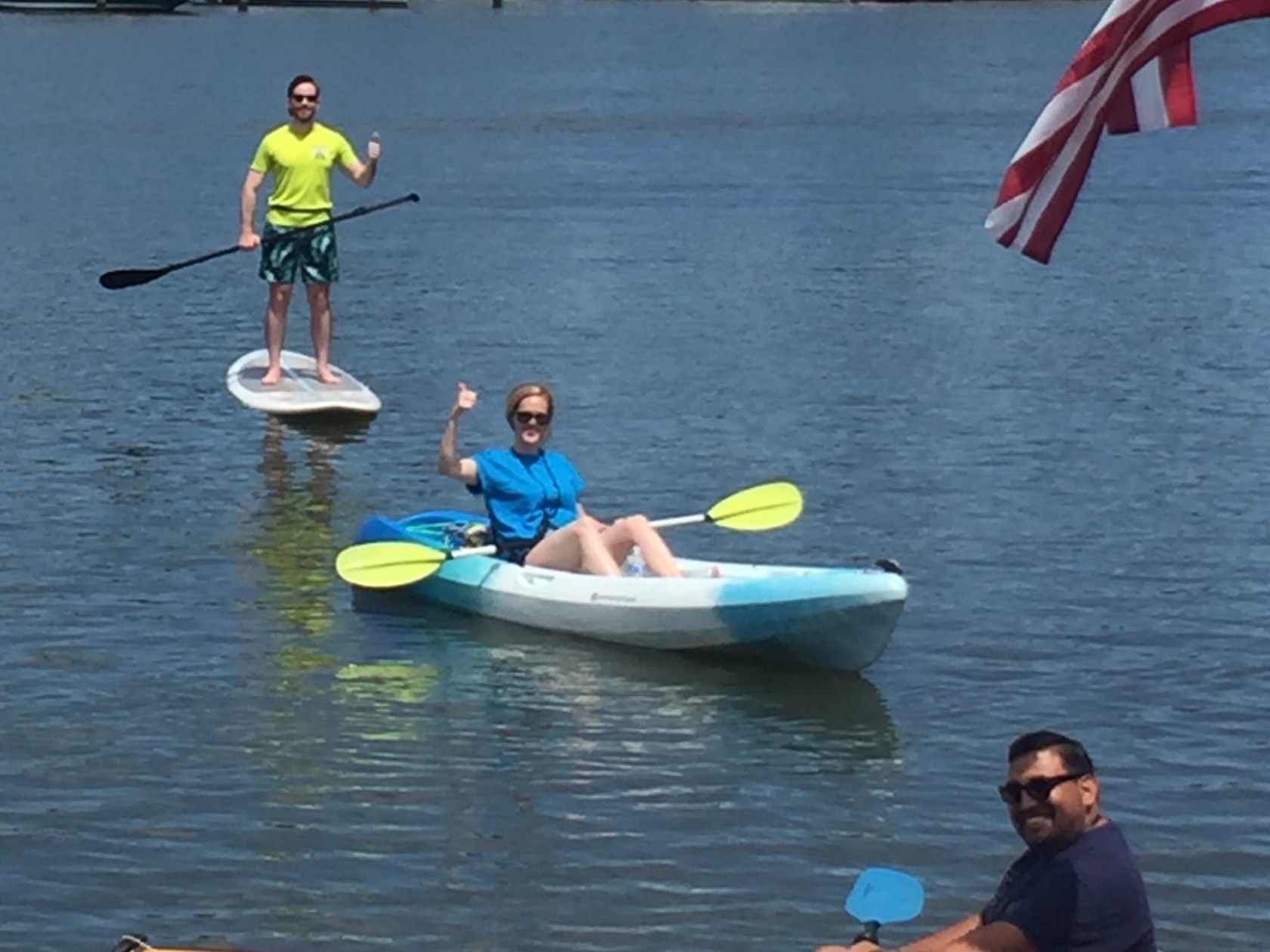 a group of people in a small boat in a body of water